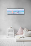 a room with a bed and a painting on the wall