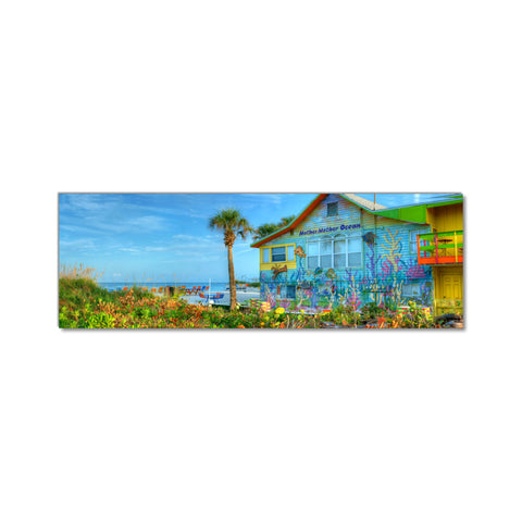 a painting of a colorful house on the beach