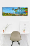 a painting of a beach house on a wall above a chair
