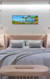 a bed with a large painting on the wall above it